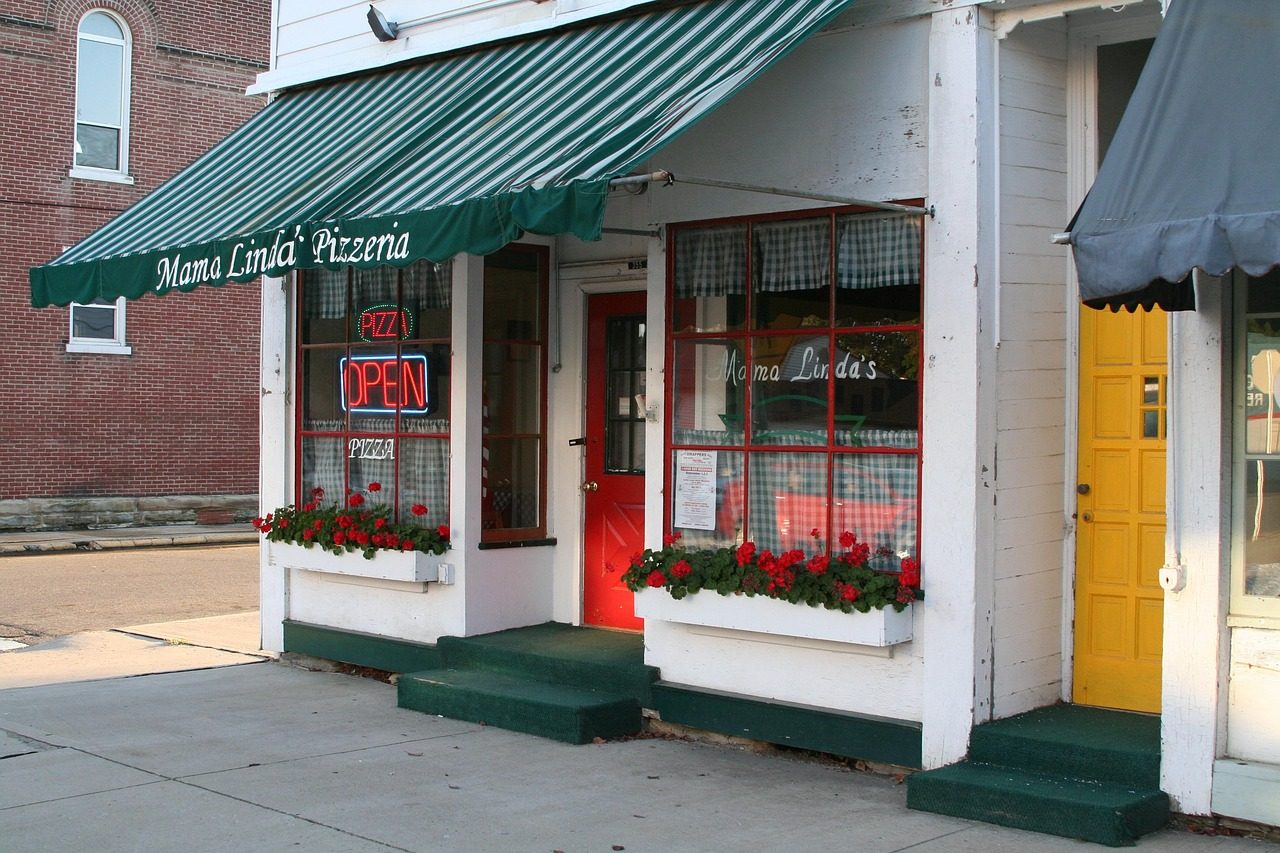 A small-town storefront with an OPEN sign, easy for customers to find